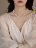 V-neck crocheted necklace that exudes elegance. Natural freshwater AK pearl necklace.